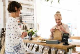 woman packaging purchase for customer